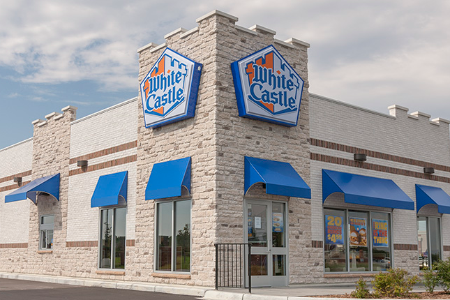 Light grays and tan stone in front of a white castle commercial building
